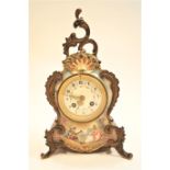 A Marti et Cie porcelain cased mantel clock, the inlaid dial with Arabic numeral and foliate swags,