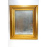 A large 21st century gilt framed mirror with deep moulded frame,
