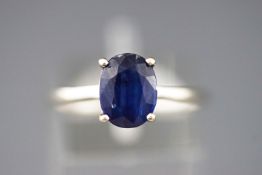 A white metal single stone ring set with an oval faceted cut Kyanite. Size P.