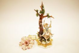 A Capodimonte figure of a girl on a swing together with a Capodimonte orchid