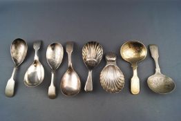 A plated fluted shell bowl caddy spoon and seven others