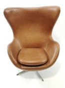 A Swedish leather upholstered revolving and reclining armchair and matching footstool