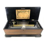 A 19th century inlaid walnut and scumbled wood German ten air cylinder music box with crank handle