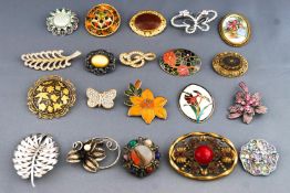 A collection of twenty costume brooches of variable designs.