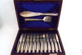 A mahogany cased set of twelve silver fish knives and forks together with a pair of fish servers,