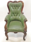 A Victorian mahogany show frame armchair with button back on cabriole legs with scroll feet