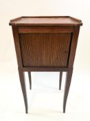 An oak pot cupboard with tambour front on square tapering legs,