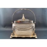 A sarcophagus shaped glass biscuit barrel, cut with swags and cross cut hobnailing,