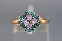 A yellow metal cluster ring set with four round faceted tanzanite