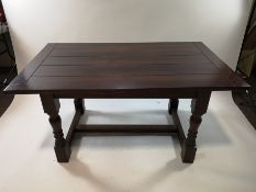 An modern oak draw leaf dining table with planked top,