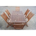 A teak effect patio suite of a table and six chairs
