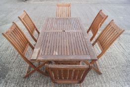 A teak effect patio suite of a table and six chairs