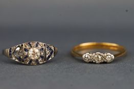 A yellow and white metal three stone diamond ring,