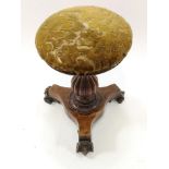 A Victorian walnut piano stool, on waisted triform base with carved scroll feet,