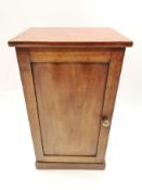 A 19th century mahogany pot cupboard with panelled door on plinth base,