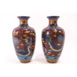 A pair of 20th century Chinese cloisonne vases, decorated in typical fashion,