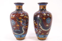 A pair of 20th century Chinese cloisonne vases, decorated in typical fashion,