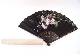 A late 19th century fan, the black fabric leaf painted with roses and flying insects,