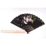 A late 19th century fan, the black fabric leaf painted with roses and flying insects,