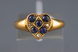 A yellow metal ring stylized as a heart and set with five round cut sapphires