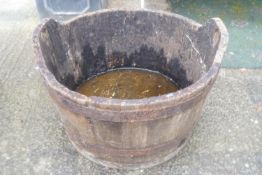 A staved wood planter, with two pierced heart shaped handles,