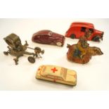 Two tin plate cars, together with a tin plate clown on a bear,