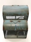Two domed animal cages, each with swing handle, the top opening with a side door,