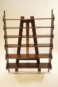 An oak hanging wall shelf, with six tiers, 133cm high, 91cm wide,