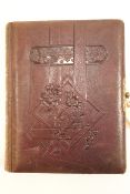Two 19th century photograph albums, with embossed leather covers,