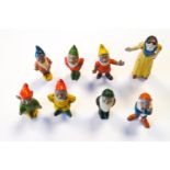 A painted cast metal set of Snow White and the Seven Dwarves, probably Britains,