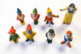 A painted cast metal set of Snow White and the Seven Dwarves, probably Britains,