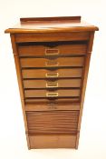 A mahogany drop tambour fronted music cabinet,