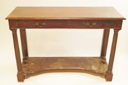 A mahogany serving table with capped fluted supports, fitted with two drawers, circa 1900,