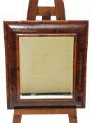 A laburnum oyster wood veneered framed bevelled mirror, of treble bombe form,