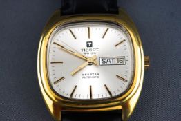 A gold plated wristwatch by Tissot.