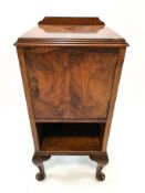 A walnut pot cupboard with one panelled door on cabriole legs,