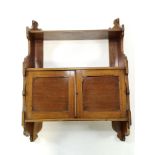 A Victorian mahogany two tier hanging wall shelf with two panelled doors overall 84cm high x 61cm