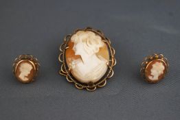 A yellow metal cameo brooch together with a matching pair of stud earrings.