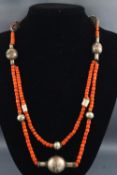 A Georgian oxidised silver necklace strung plain and finished with coral beads.