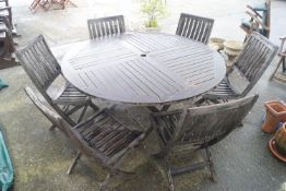 A Prestige teak garden table and six folding chairs