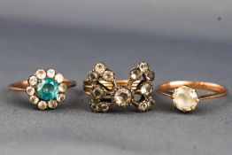 A collection of three yellow metal dress rings set with white sapphires/zircons and blue zircon