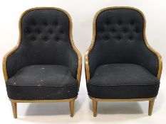A pair of mid 20th century style armchairs with oak show frames upholstered in black