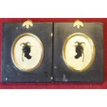 A pair of silhouettes on mirrored backgrounds in ebonised frames,