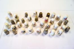 A group of thimbles (approximately 42), including some in silver, and examples by Royal Worcester,
