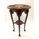 A mahogany jardinere stand with carved top, on cabriole legs linked by an under tier,