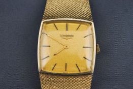 A yellow metal wristwatch by Longines. Cushion square dial with gold backing and baton markings.