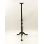 A mahogany torchere, the cabriole legs with ball and claw feet,