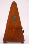 A French mahogany cased metronome, on bun feet,