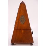 A French mahogany cased metronome, on bun feet,