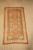 A Kazak Karatchop rug with five alternating geometric medallions within multiple borders,